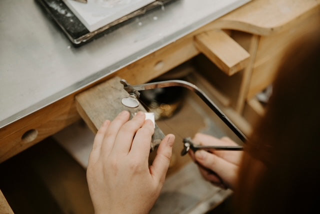 hands using a jeweler's saw